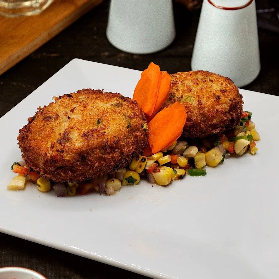 Salad with corn, two panda cakes and pieces of carrot