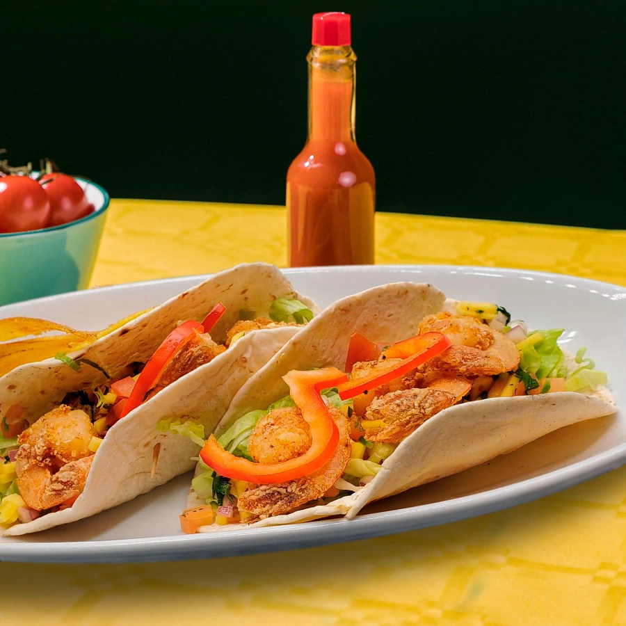 Plate of two tacos stuffed with salad